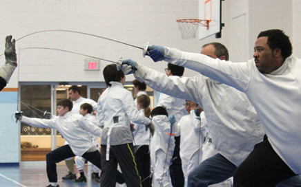 A student lunges during adult classes at Tidewater Fencing Club.